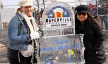 Kim Cook and Joann Doody have fun posing with the ice sculpture.