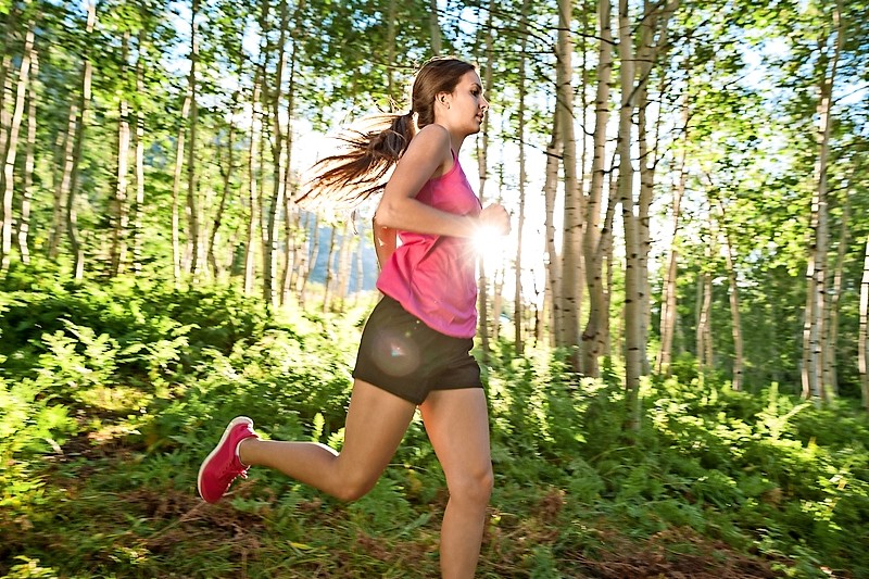 Fitness Girl Running in Aspen Grove at Sunset