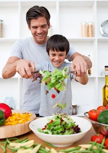 Little boy and his father cooking