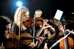 Serious violinist in female quartet.