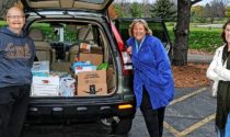 Naperville Sunrise Rotary community service chair Bill Hassett, volunteer Deb Newman, and club president Stephanie Randall collect food and toys for West Suburban Community Pantry Harvest Drive November 5.