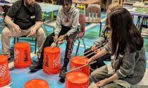 Kids drumming on buckets