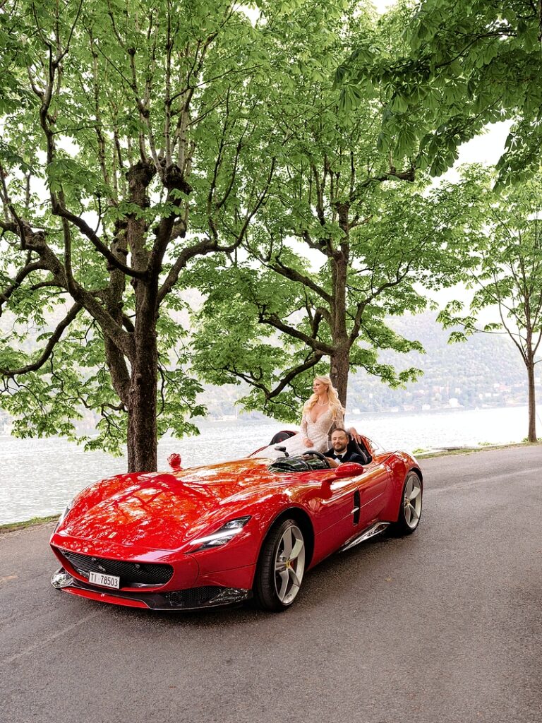 The couple driving to their wedding's cocktail hour in a Ferrari