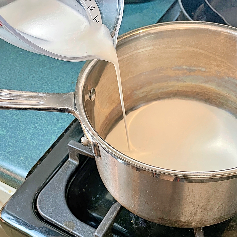Warming cream in a saucepan