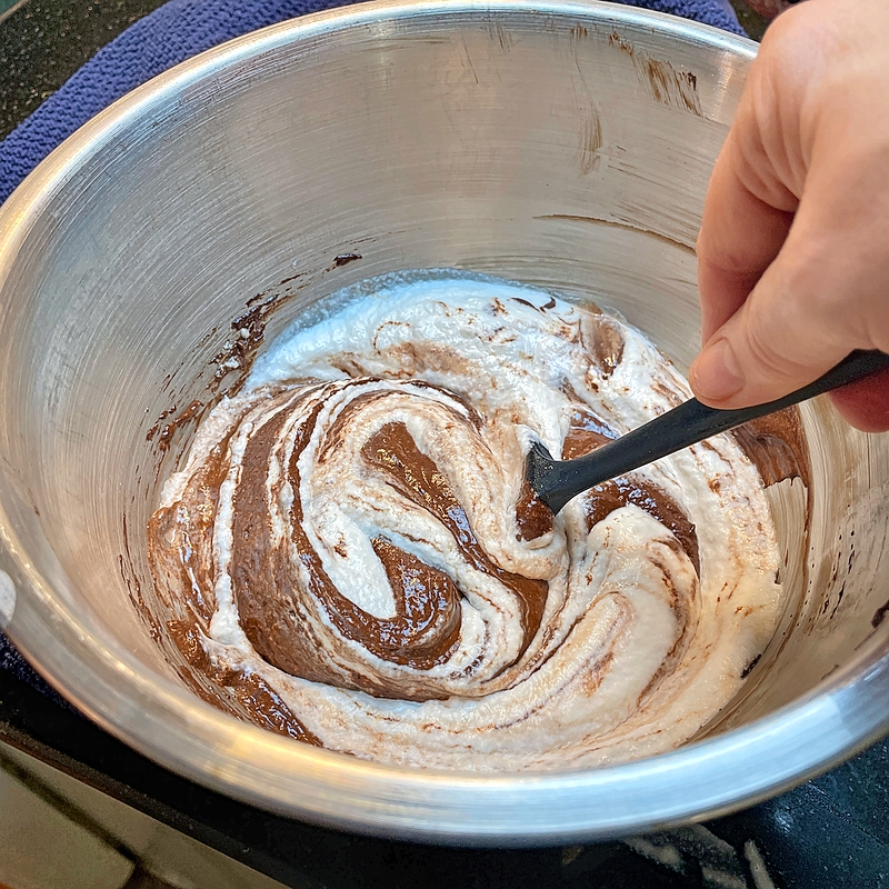Folding egg whites into the chocolate mixture