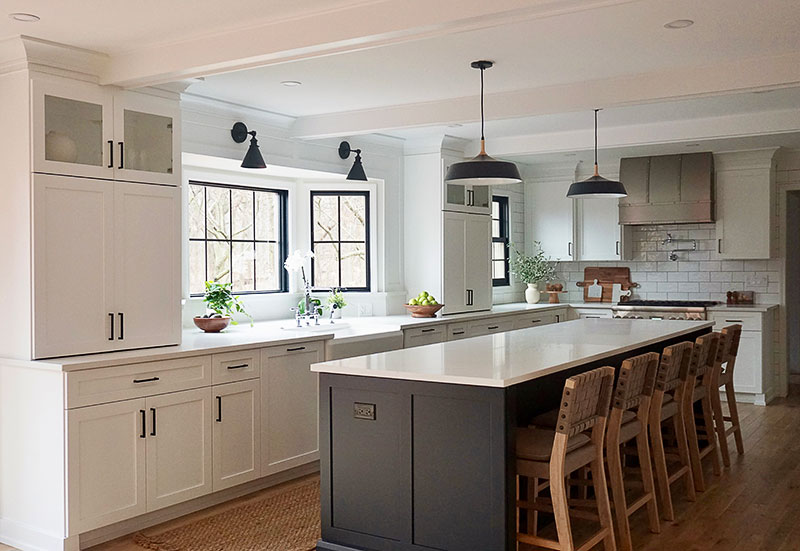 “Because the homeowners are very social and have large families and a lot of friends, they truly needed the kitchen to grow,” designer Elizabeth Prignano says. “We completely reimagined the layout to eliminate the peninsula from the original kitchen and almost doubled it in size, incorporating a jumbo island where they could seat five stools.” The counter stools are by Nathan James, pendants are by Shades of Light, and sconces are by Three Posts.
