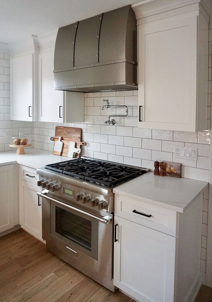 “Because the homeowners entertain so much, we wanted to give them this chef’s kitchen with oversized appliances,” Prignano says. “They have a 36-inch range and a pot filler above.” The custom-made hood with stainless-steel strapping was custom-made by Hoodsly in Denver, North Carolina.
