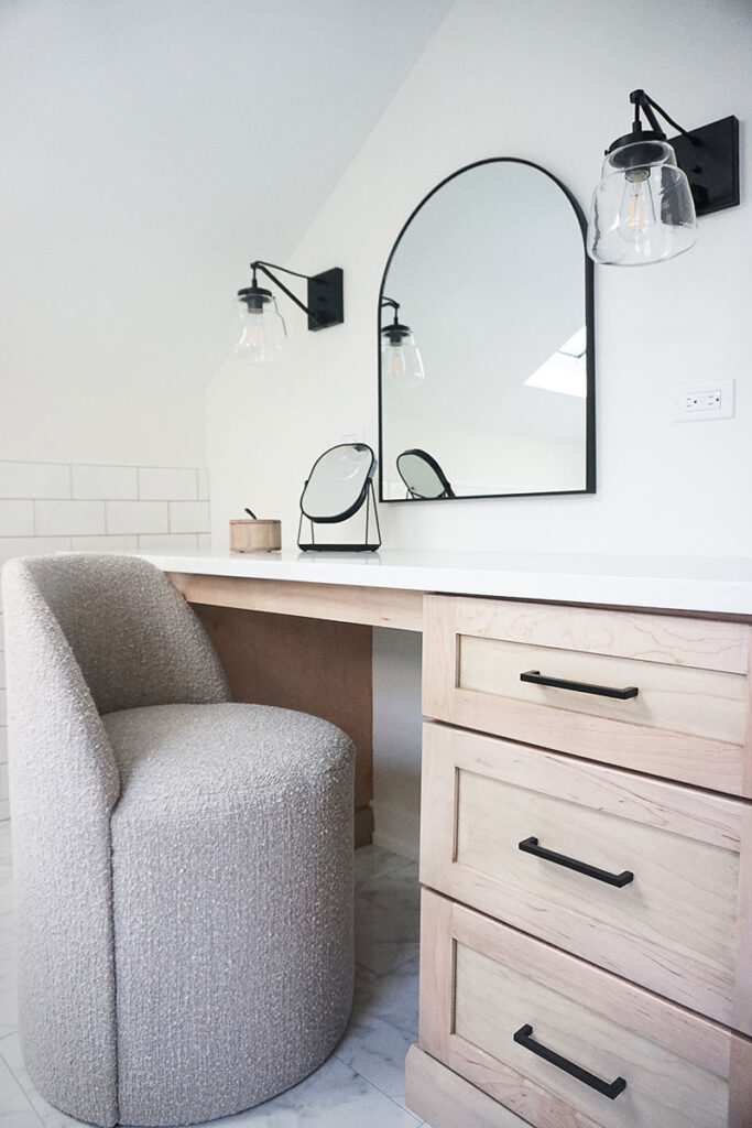 The homeowners originally asked for their washer and dryer to be relocated to the primary bathroom, but when the utility work needed to make that happen ended up being unreasonable, Prignano pivoted and created this vanity space. With natural light streaming in from an existing skylight above, it’s the perfect spot to get ready in the morning.