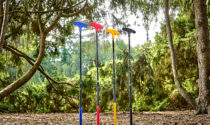 Colorful putters standing on end in an area surrounded by trees