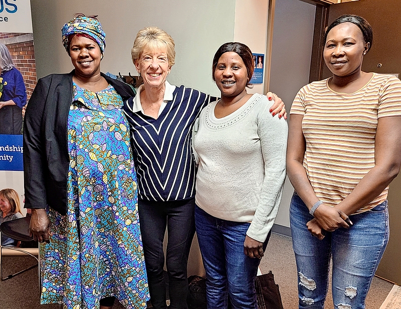 A retired literacy teacher (second from left) leads an English conversation group for refugee women.