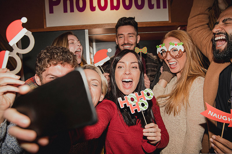 People taking a selfie at a Christmas party