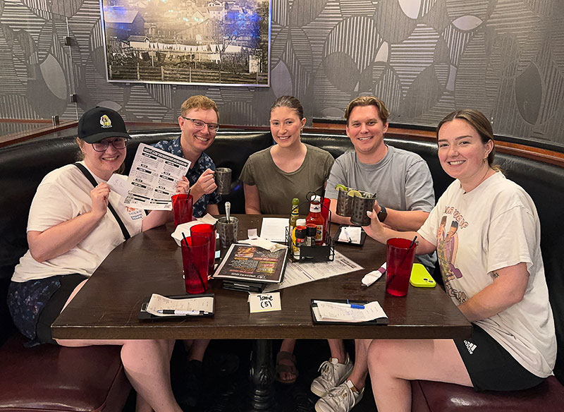 A group of Go 4 It Entertainment players at a table