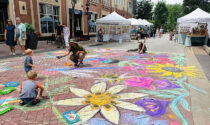 On July 13, the second annual Water Street Fine Art & Fine Craft Fair showcased 18 regional artists who work in painting, ceramics, glass, wood, and digital art. Two artists from the DuPage Children’s Museum (above) created a floral chalk street mural, inviting the fairgoers to collaborate.