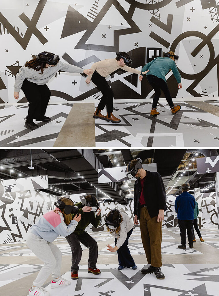 Visitors wearing VR headsets and navigating the space at EXP