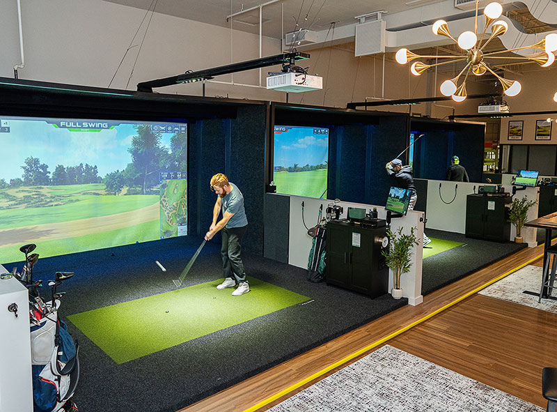 Indoor golfers in the bays at Lucky Swingz