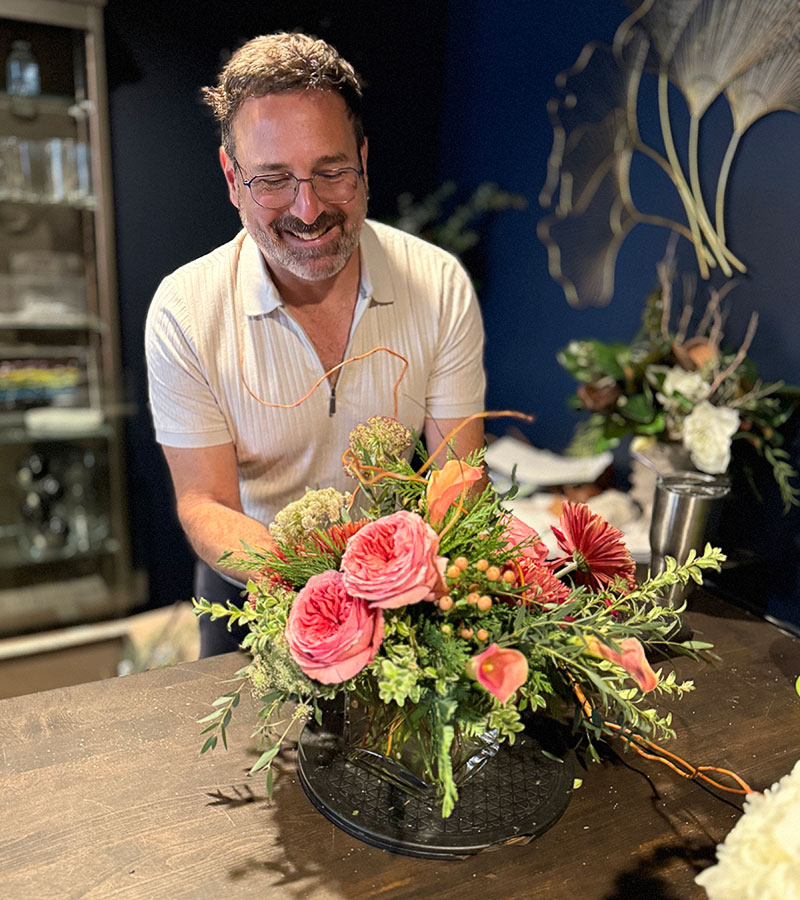 Andrew Parravano with a flower arrangement at 6th and Foster