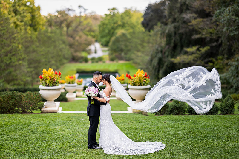 Dana Giragosian and Rob Fortino in wedding attire, embracing in Cantigny Park.