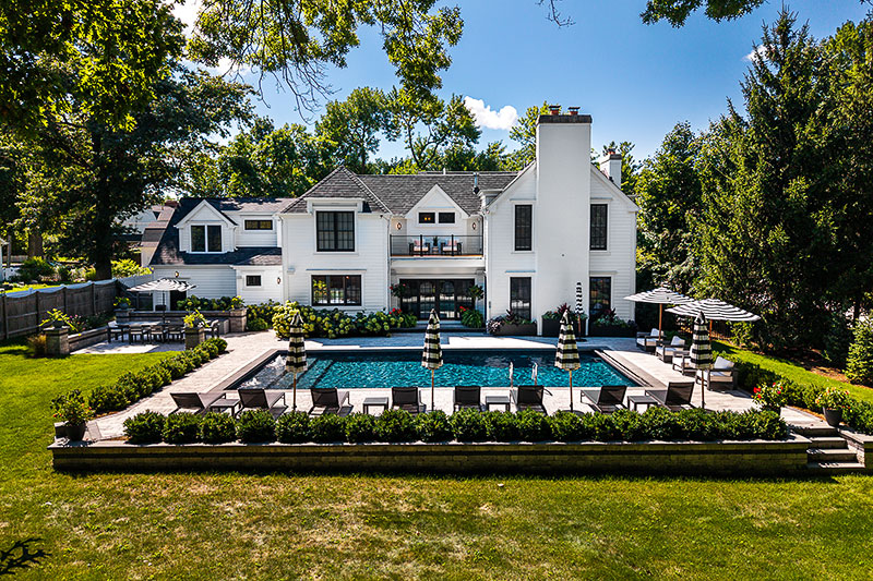 The back exterior and pool area of the Geneva home