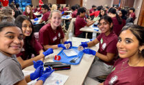 A group of girls wearing latex gloves performing a dissection at Dr. Rubin’s Mini Medical School