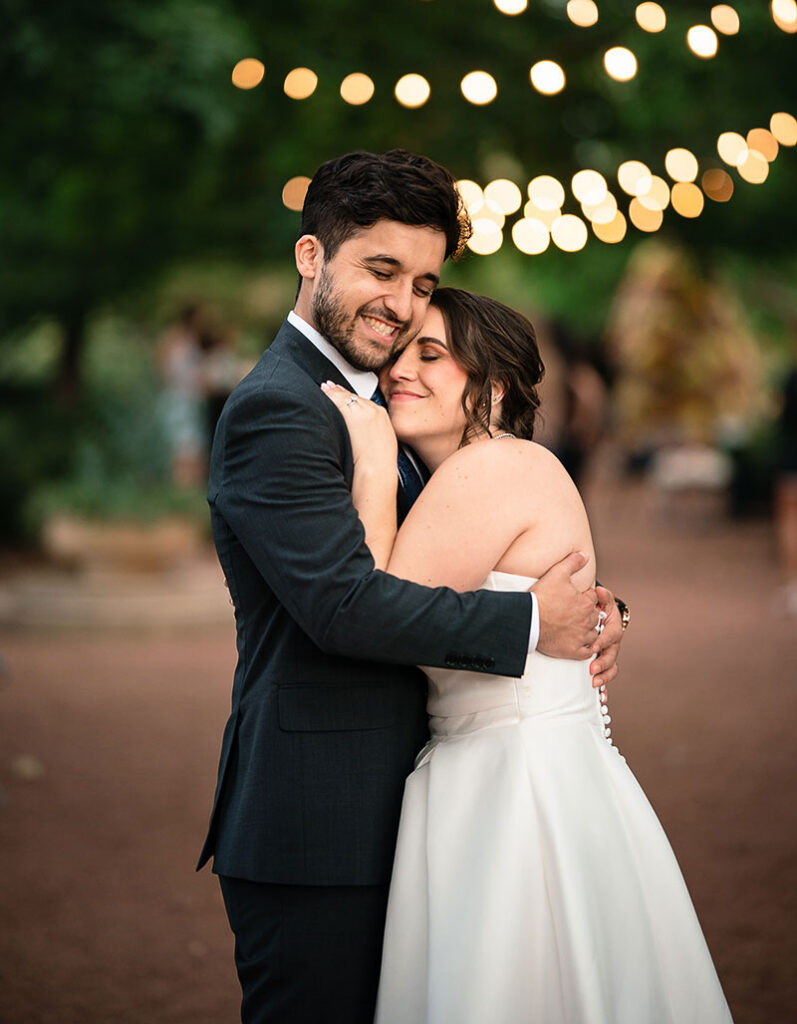 Alex Senak and Lauren Kelliher hugging in their wedding attire