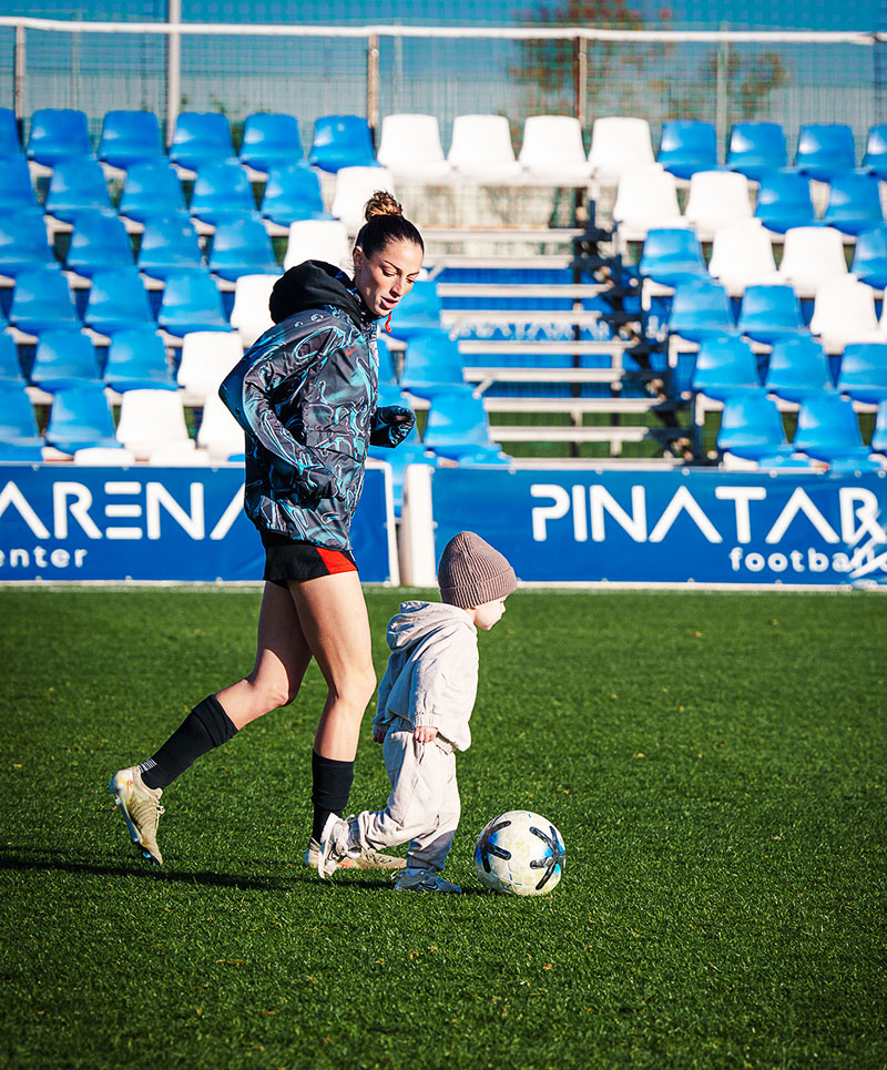 Ryan Gareis playing soccer with her young son