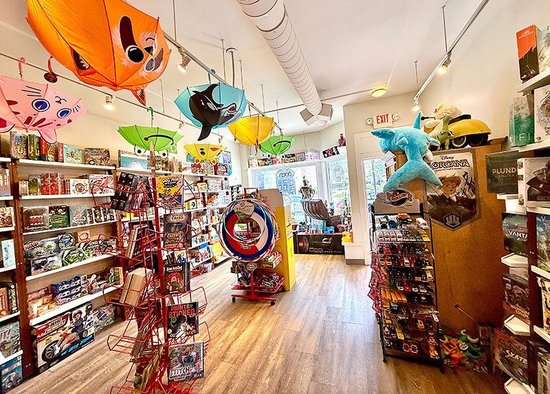 A plush shark and a variety of cards, games, and toys at Treasures