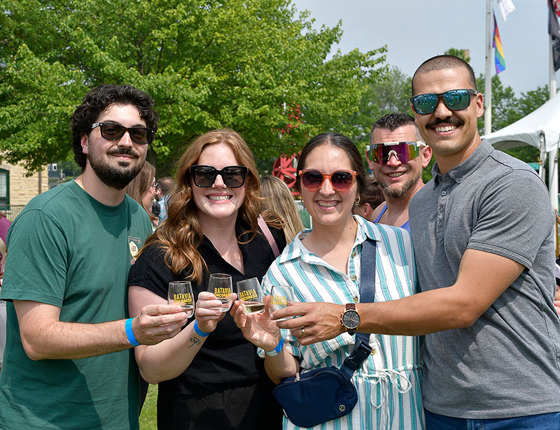 Visitors holding wine at Batavia Uncorked
