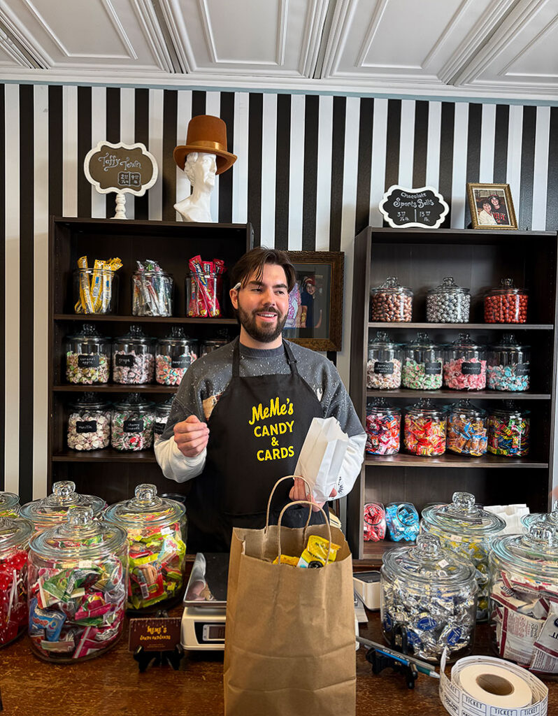 An employee bagging items at MeMe’s Candy & Cards