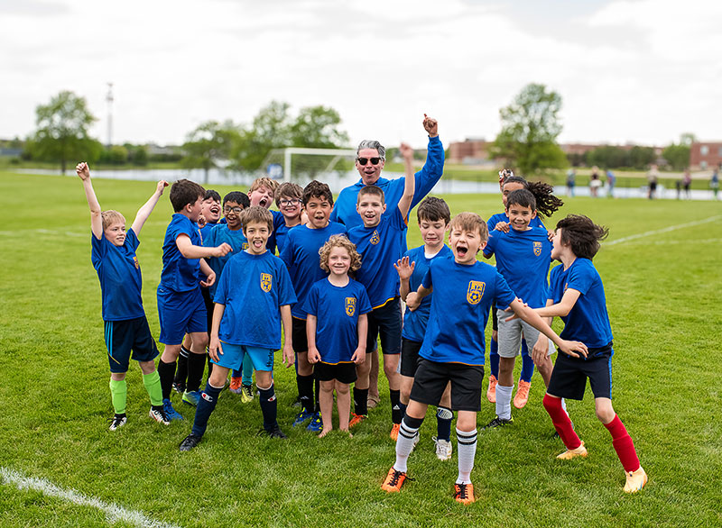 Tyler Miller with kids on a soccer field