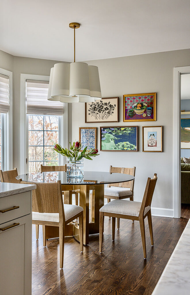 A gallery wall featuring five art pieces in the Lemont home’s informal dining area