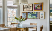A gallery wall featuring five art pieces in the Lemont home’s informal dining area