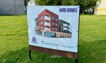 A sign displaying a Hero Homes rendering