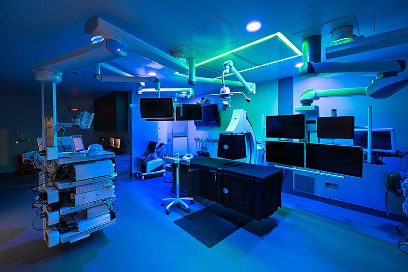A large room with medical equipment and several monitors lit with blue light at the Center for Advanced Endoscopy at Central DuPage Hospital in Winfield
